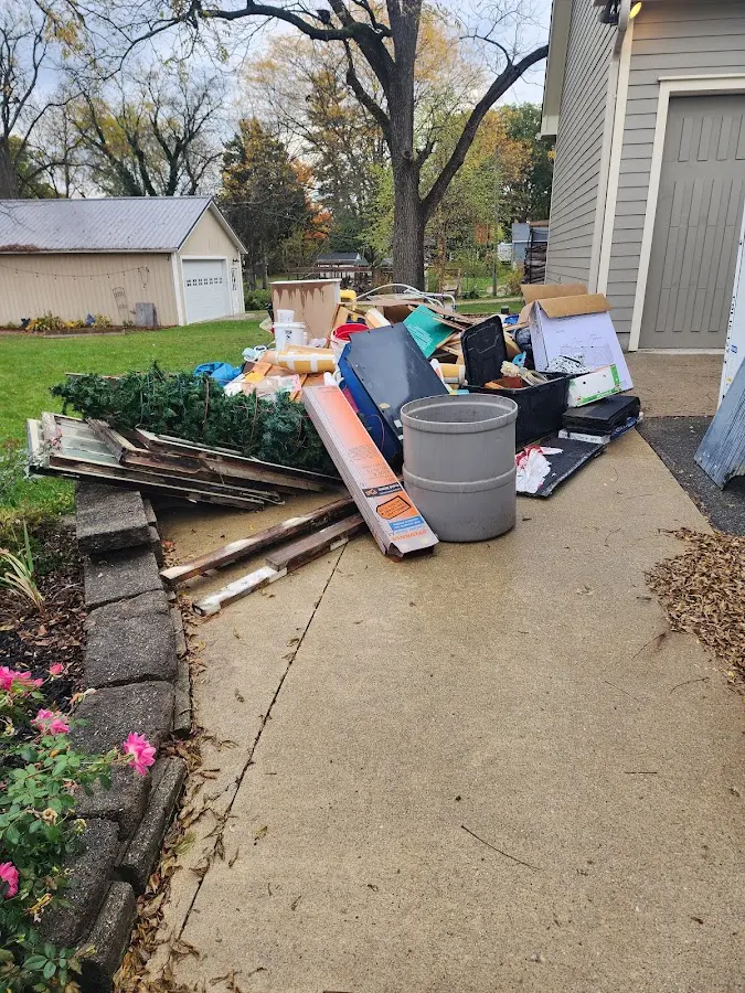 Dumpster being loaded with debris for Estate Cleanout Dumpster Rental in Bethel Manor